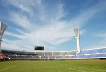 a stadium with a large white tower